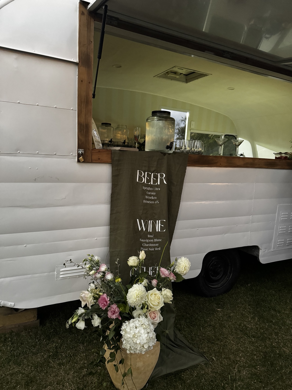 The serving window, timber bar and floral arrangement