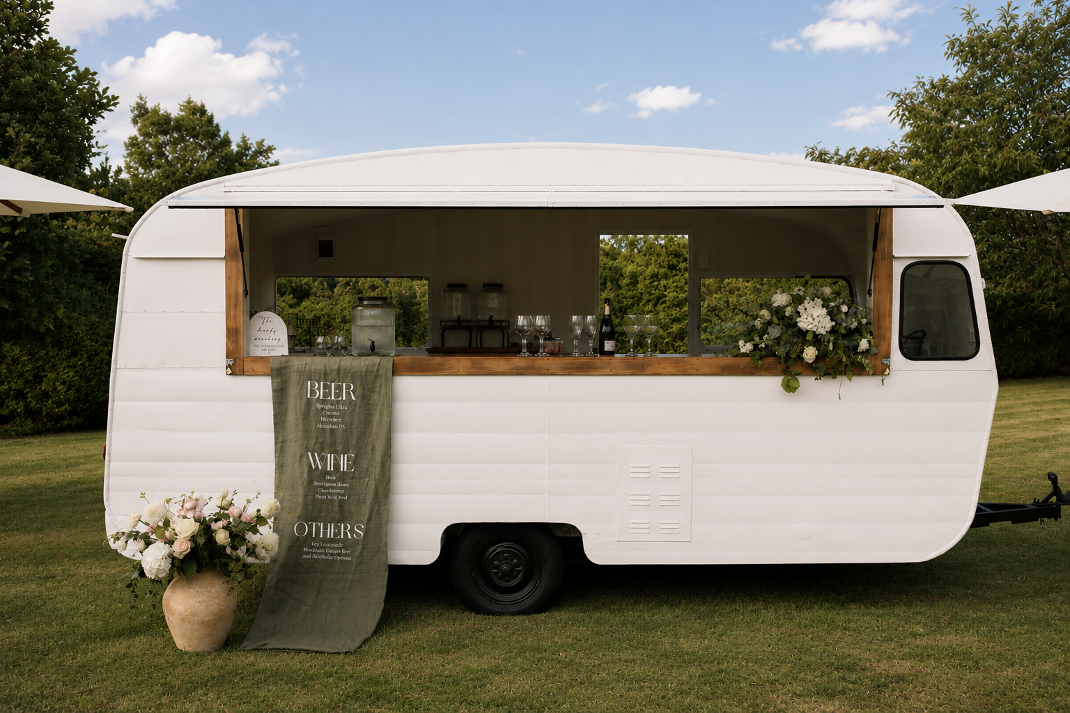 Full view of The Tipsy Gypsy caravan bar at an outdoor event